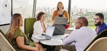 Several individuals having a meeting in a conference room.