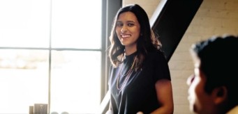 An individual standing and smiling.